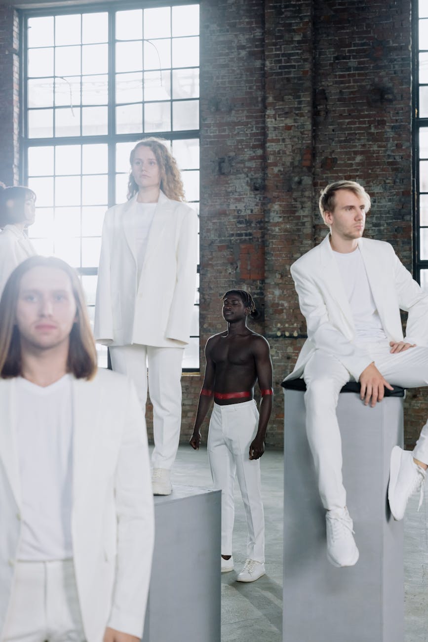 A group of diverse people sitting calmly in a bright, modern studio.